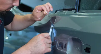 Paint protection film being applied to a car hood